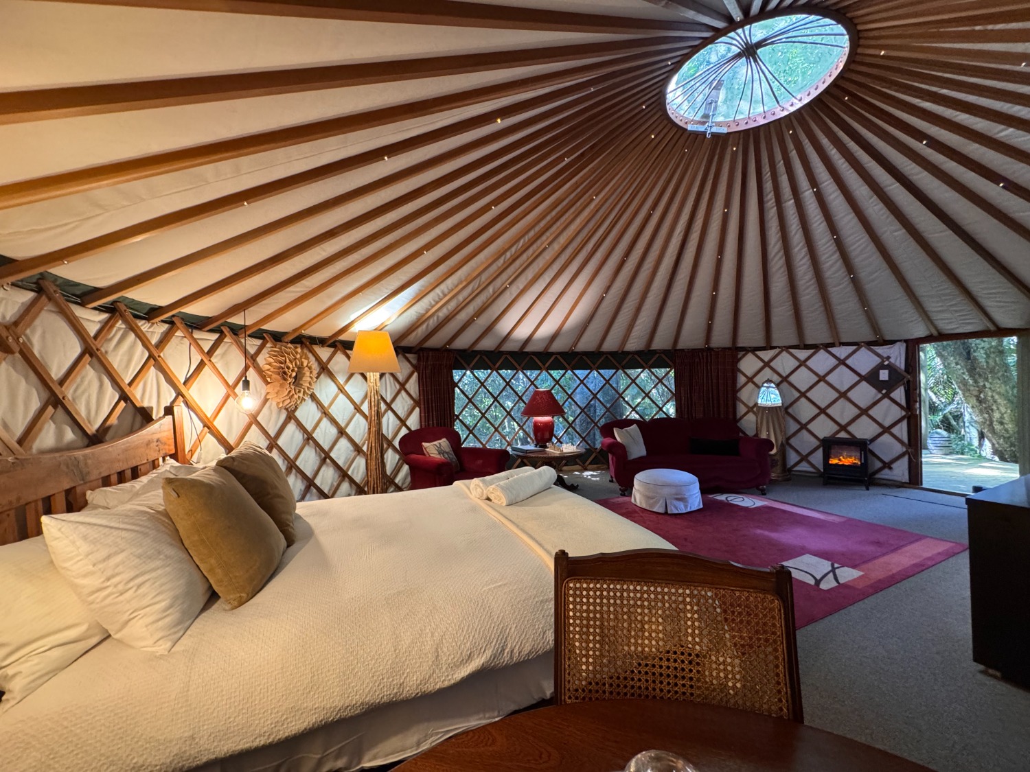 Beautifully furnished yurt interior at Nīkau Sanctuary with natural textures and peaceful vibes